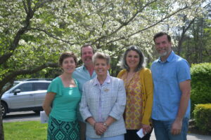 A group photo of five people standing next to one another