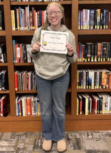 Esther Nwefo posing with her Student of the Month certificate