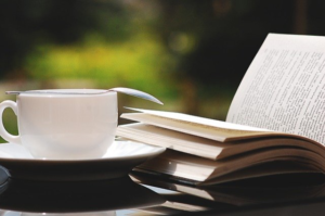 a coffee cup and an open book