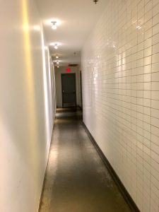 Chipotle's bathroom, which is relatively hidden from the open eating area and requires the user to walk through a long hallway to access 
