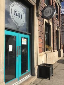 A photo of the front entrance of the 541 Eatery and Exchange in Hamilton, Ontario, which is a distinctive blue color.