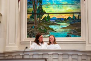 An image of a pastor with a young baptismal candidate at First Baptist Church, Winchester, VA