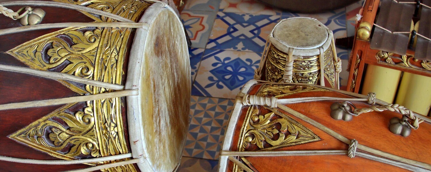 The image shows the drums and instruments that would be played in traditional Javanese gamelan ensemble while dancers are preforming gambyong