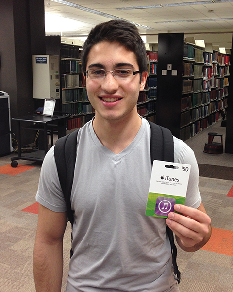 Photo of a student holding an iTunes gift card