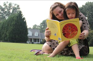 Photo of a mom reading a book to her daughter