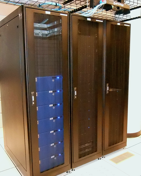 Photo of three cabinets containing VNX & Isolon storage