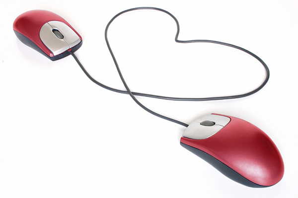 Photo illustration of a two computer mouses forming a heart shape
