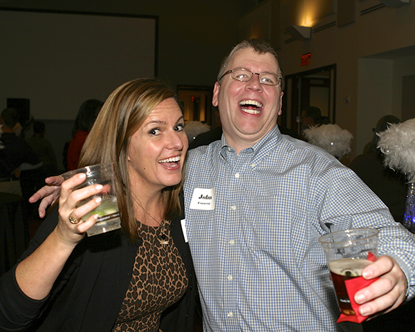 Photo of two staff members enjoying a party