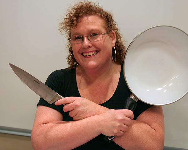 Photo of Christina Mazzella holding cooking implements