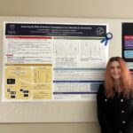 Brooke standing next to an academic poster with her Senior thesis findings.