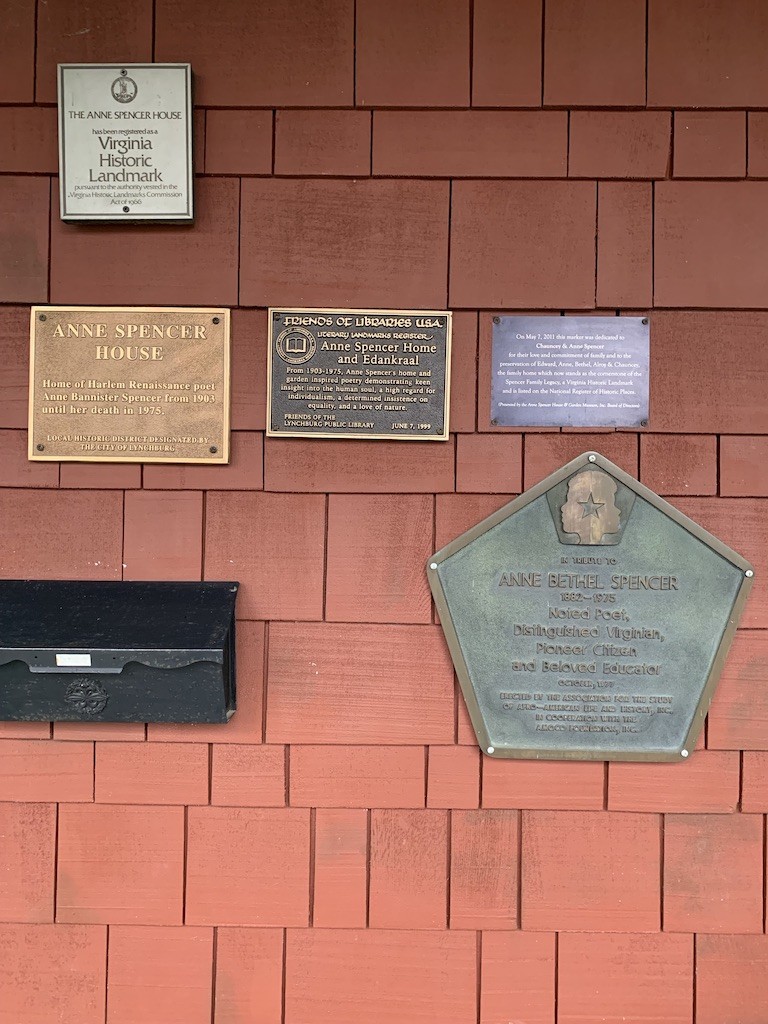 Collection of five plaques of historic designations granted to the Museum--posted on the front of the house.