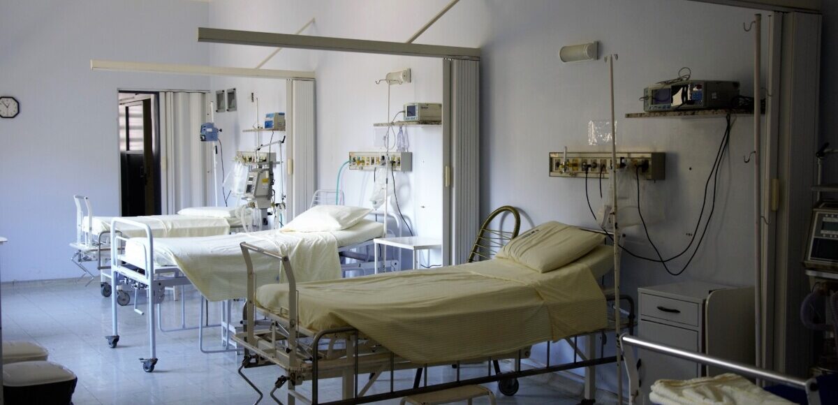 A hospital room with three beds