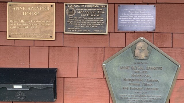 Collection of five plaques of historic designations granted to the Museum--posted on the front of the house.