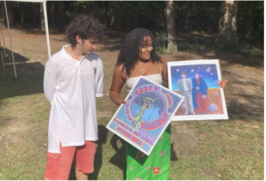 Royce Mann and Jaanaki Radhakrishnan admire prints by renowned Mvskoke artist Johnnie Diacon, whom they met the at the Indigenous Celebration. 