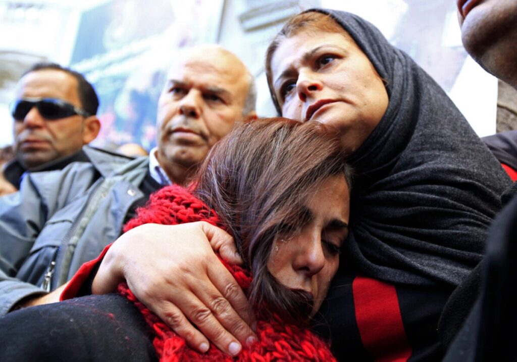 The mother (R) of photographer Nadhir Ktari, who disappeared with fellow journalist Sofiane Chourabi in Libya in September, attends a demonstration held in solidarity with the missing pair, in Tunis January 9, 2015, REUTERS/Anis Mili