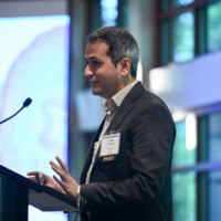 Farzad Fereidouni, PhD, presenting "Intra-Operative Pathology: The Triple Trouble" Photo of man speaking at podium