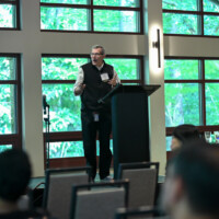 Philip Santangelo, PhD, presenting "Hyperpotent formulations for lung delivery of nucleic acids" and "Next generation prophylaxis against nerve agents" Photo of man speaking at podium