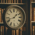 Analog clock hovering over book shelves - AI generated
