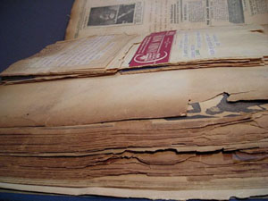 Side view of the scrapbook created by vaudeville performer Johnny Hudgins, revealing the enormity of the book and the brittle nature of its pages.