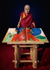 Dalai Lama with Murals of Tibet
