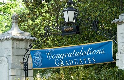 Emory gate with 'Congratulations Graduates banner