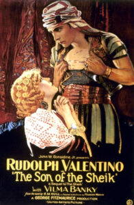 Movie poster for The Son of the Sheik. Rudolph Valentino gazes down at a pleading woman.