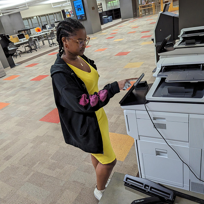 A student uses one of the new printers in the Woodruff Library with EaglePrint’s new streamlined software.