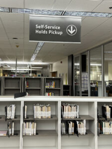 Self-service holds shelving located next to the Level 2 Service Desk.