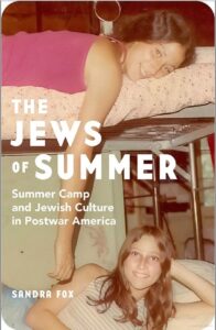 Cover of Sandra Fox's book with color photograph of two young women on a bunker bed and the title printed in white.