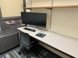 Study room with desk, chair, and docking station.