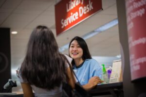 Students talking at the Woodruff library 2nd floor service desk