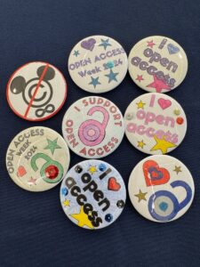 Colorful handmade buttons that say "I heart Open Access" or feature and icon of an open lock.